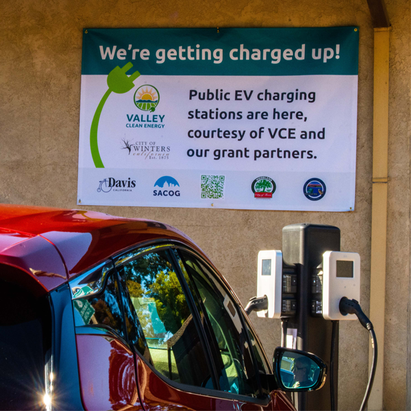 EV charging with celebration banner on the wall ahead of it.